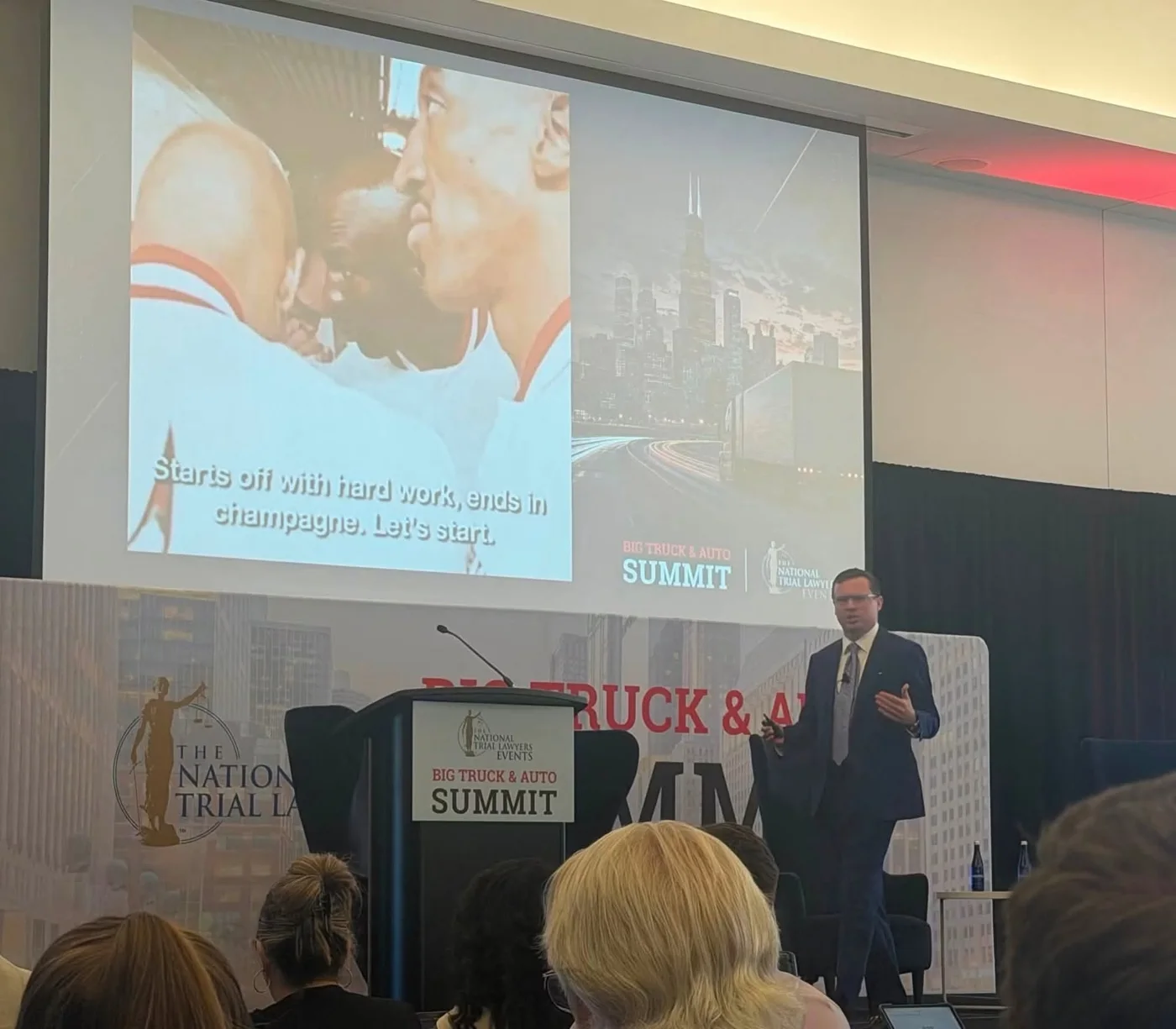 Jon Hollan at the podium end of the stage during his Big Truck and Auto Summit session